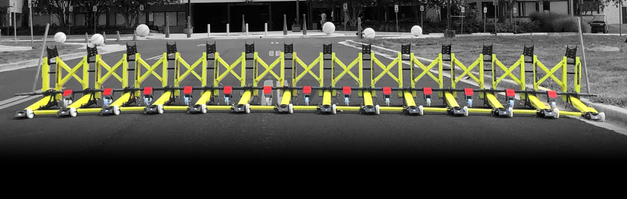 Yellow MVB3X modular vehicle barriers arranged across a roadway.