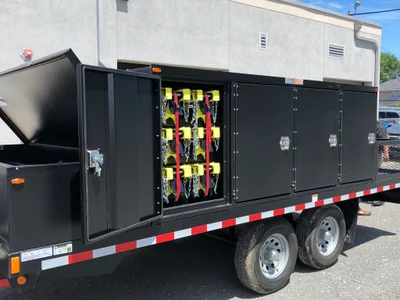 AST trailer storing vehicle barrier units.